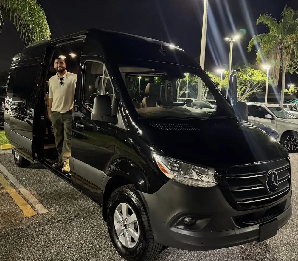 Prime Ride Shuttles black Mercedes Sprinter with chauffeur at night