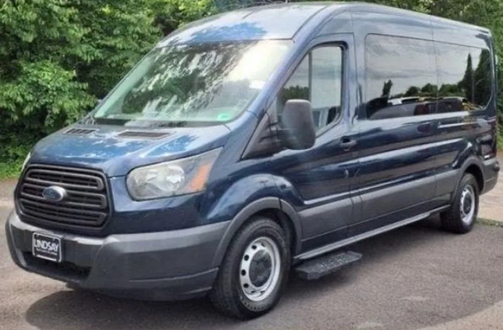 Prime Ride Shuttles blue Ford Transit shuttle van