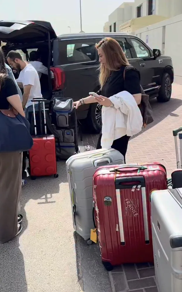 Chauffeur loading luggage into a Prime Ride vehicle