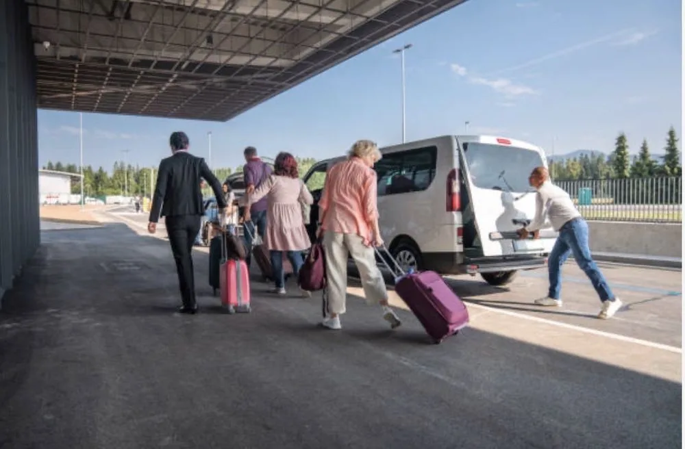Travelers boarding a Prime Ride Shuttles van at the airport